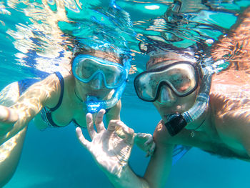 Portrait of couple snorkeling in sea