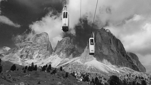 View of ski lift over snow covered mountains