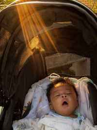 Portrait of cute baby sleeping in stroller