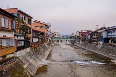 Canal amidst buildings in city