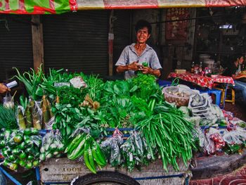 Portrait of man for sale at market stall