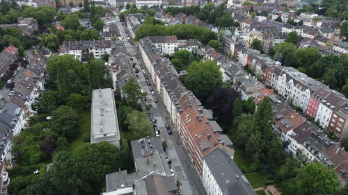 High angle view of street amidst trees in city