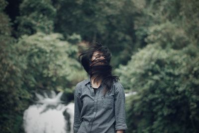 Woman with tousled hair outdoors