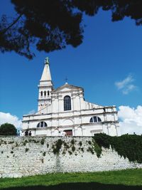 Low angle view of church against blue sky