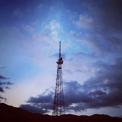 Low angle view of communications tower against sky