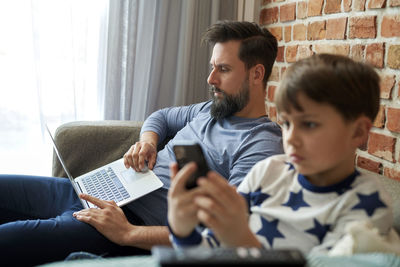 Boy using laptop at home