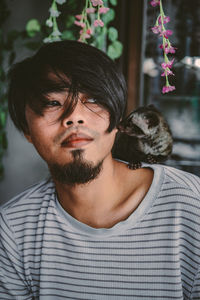 Close-up of young man with meerkat