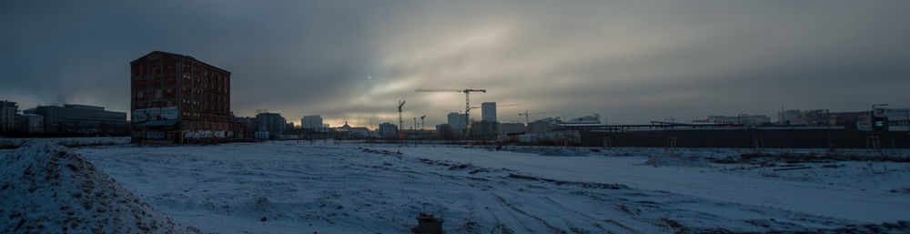Panoramic view of city during winter against sky