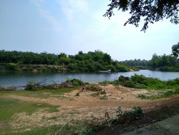 Scenic view of river and landscape against sky