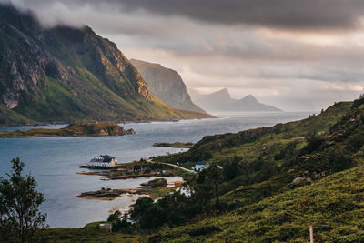 Scenic view of sea and mountains against sky