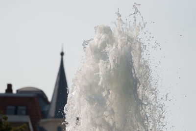 Close-up of water splashing against clear sky