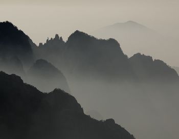 Scenic view of silhouette mountains against sky