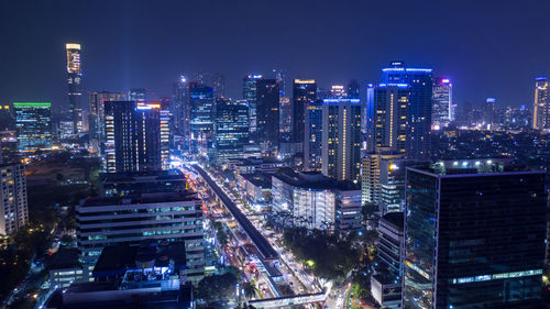 High angle view of illuminated buildings in city at night