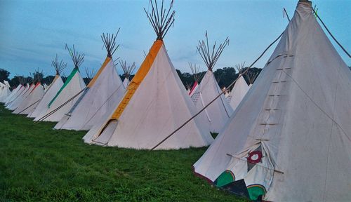 Clothes drying on field against sky