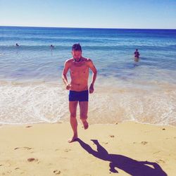 Full length of man on beach against sky