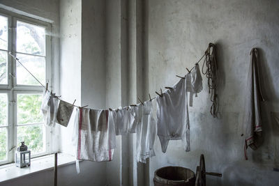 Clothes drying against white wall at home