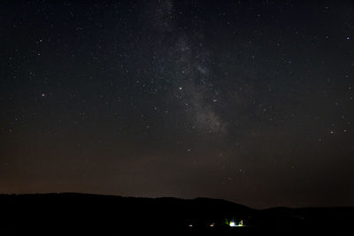 Scenic view of silhouette landscape against star field at night