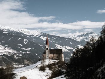 Church on mountain peak against sky