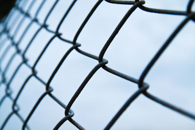 Full frame shot of chainlink fence against sky