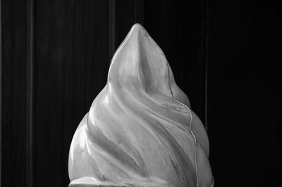 Close-up of ice cream cone against black background