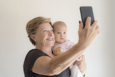 Grandmother taking a selfie with her granddaughter