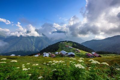 Scenic view of mountains against cloudy sky