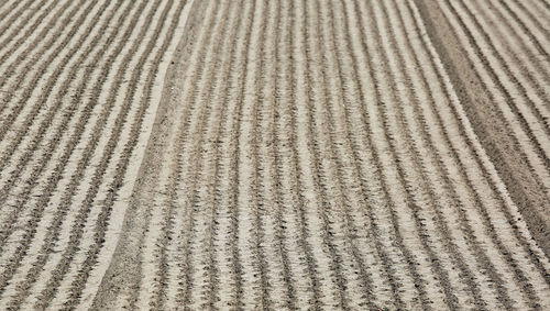 Full frame shot of tire tracks on sand