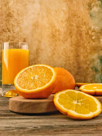 Orange fruit slices and fresh juice on table