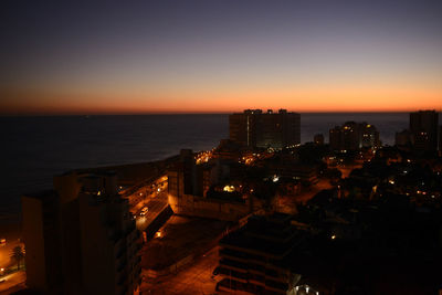 High angle view of illuminated buildings against sky during sunset