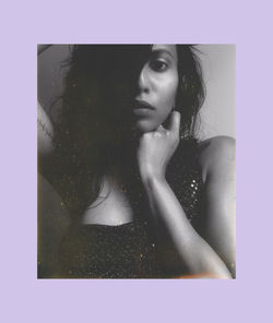 Portrait of beautiful woman against black background