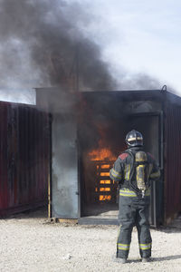 Rear view of firefighter working outdoors