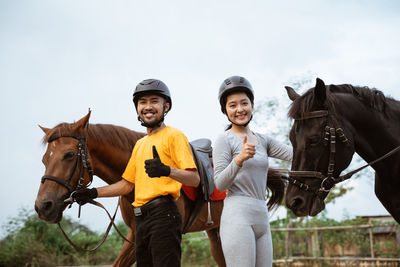 Portrait of man riding horse on field