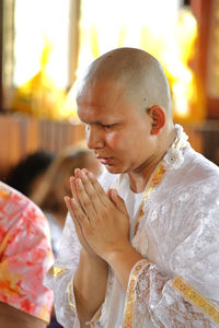 Monk praying during ordination
