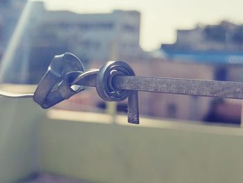 Close-up of chain hanging on railing