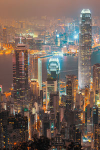Illuminated cityscape against sky at night