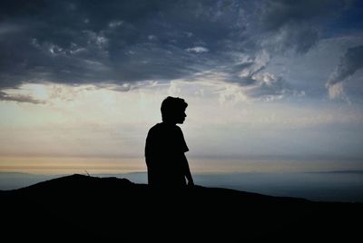 Silhouette of of boy on landscape