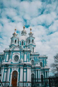 Low angle view of building against cloudy sky