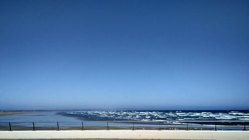 Scenic view of sea against clear blue sky