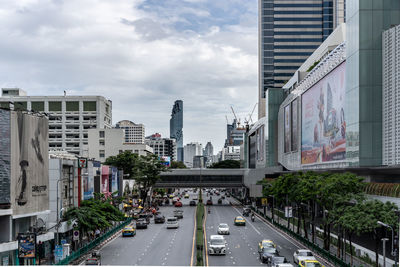 View of city street and buildings against sky