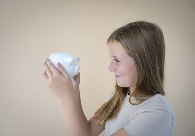 Young woman holding piggy bank