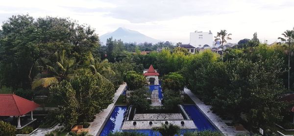 Panoramic view of trees and buildings against sky