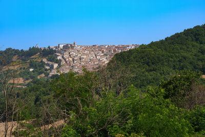 High angle view of townscape against clear blue sky