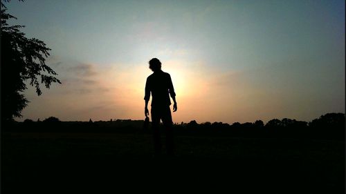 Silhouette of woman standing on landscape