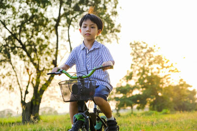 Full length of boy riding bicycle at park