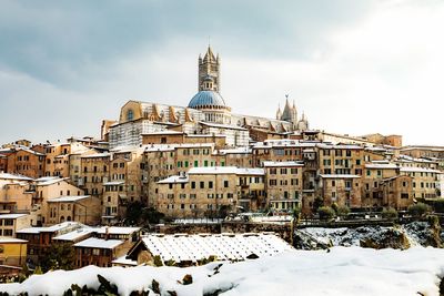 Low angle view of old town and church against sky