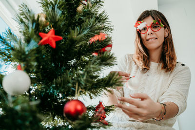 Young woman with christmas tree