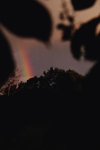 Low angle view of rainbow against sky at sunset