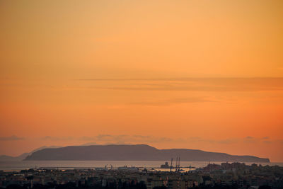 Silhouette buildings against sky during sunset