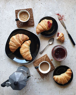 High angle view of coffee and croissants on stone table