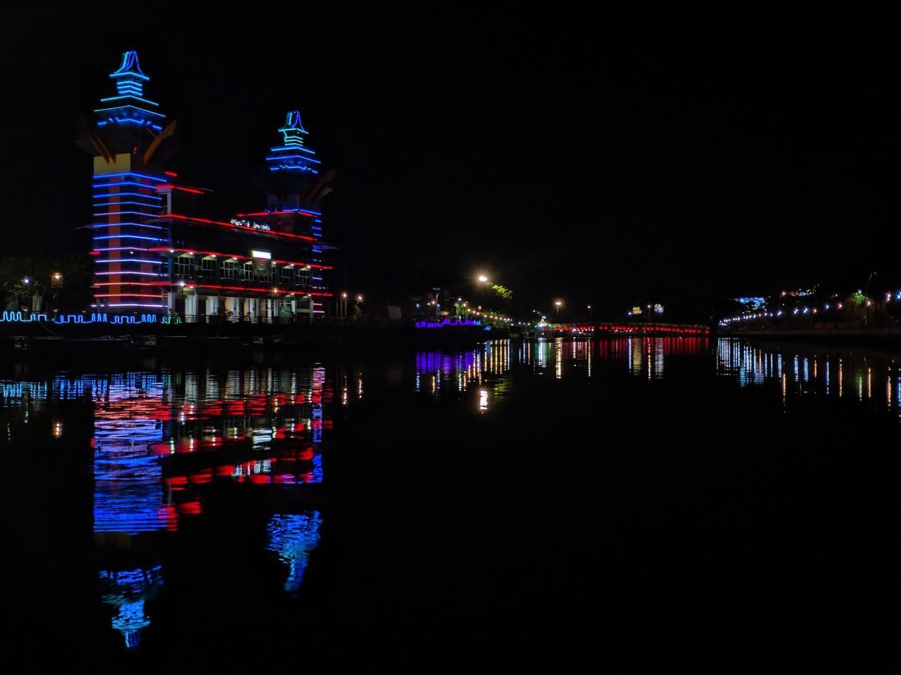 REFLECTION OF ILLUMINATED BUILDINGS IN LAKE